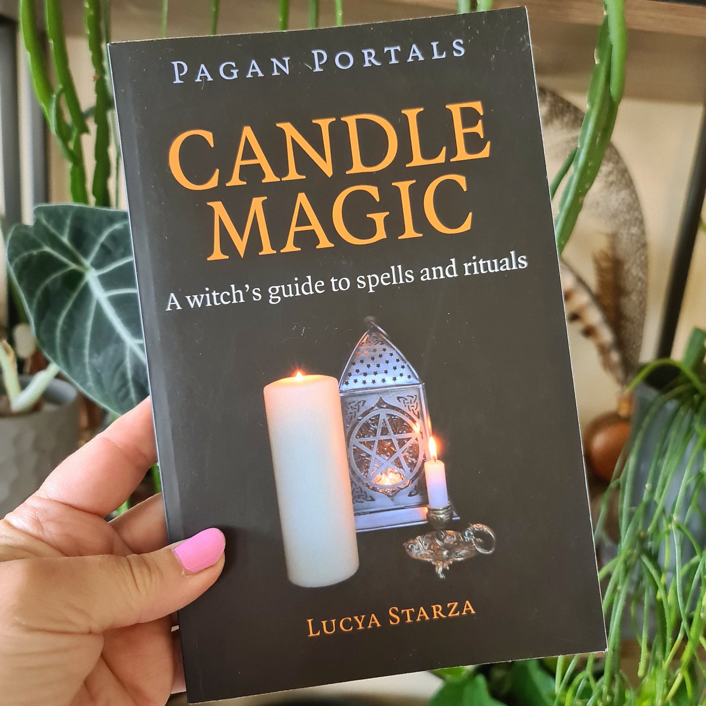 black soft cover book held in a hand