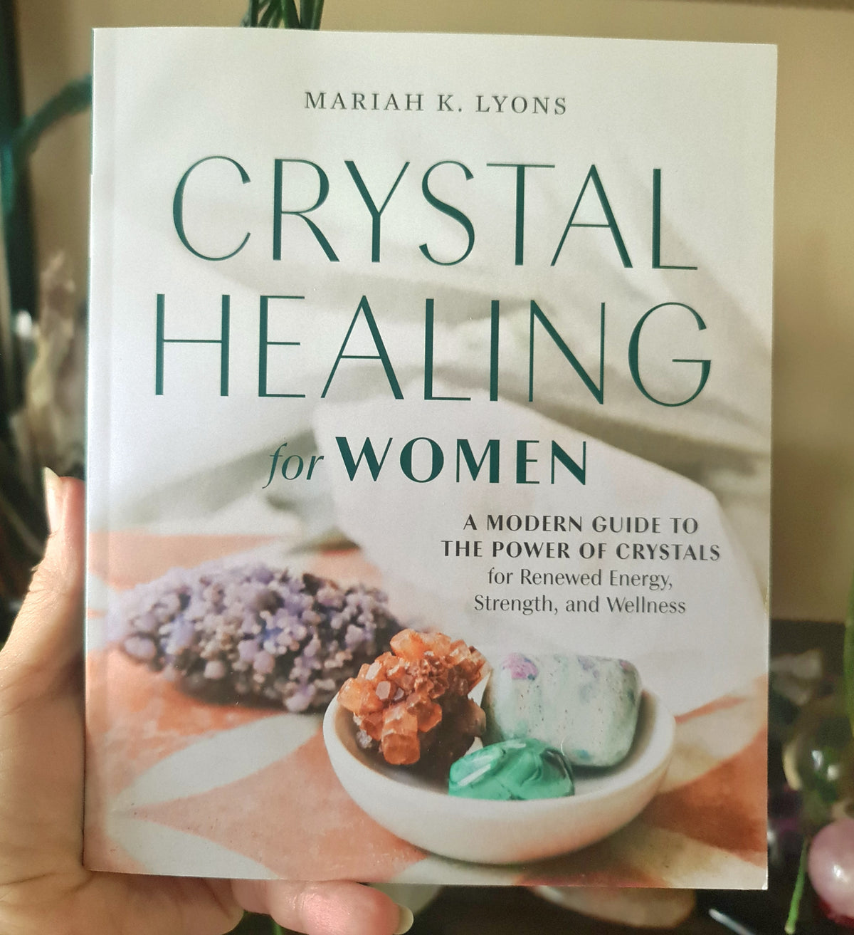 softcover crystal healing book in a hand