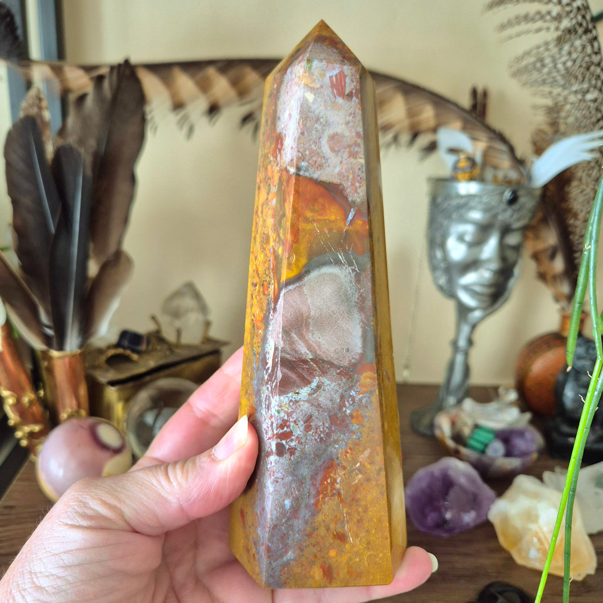 large ocean jasper tower held in a hand