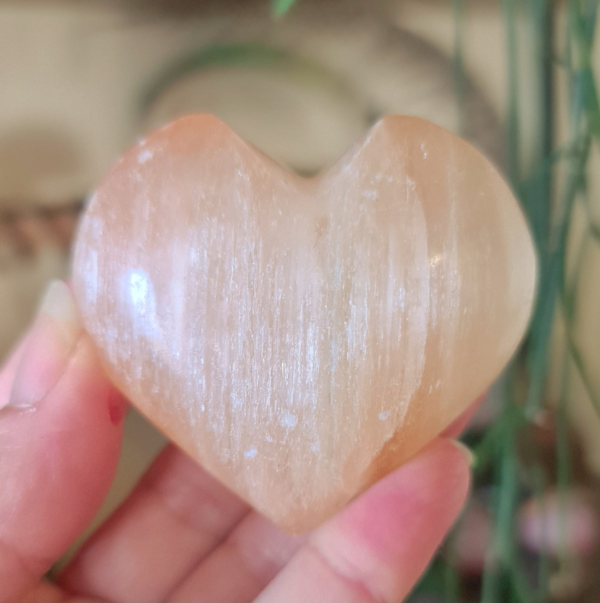 pale peach crystal heart in a hand