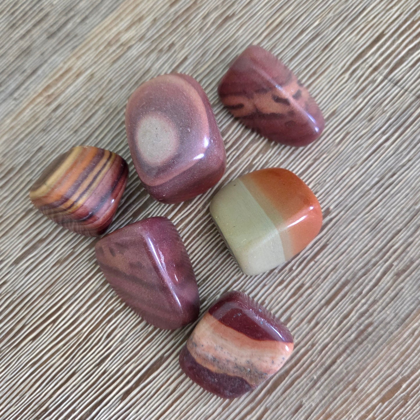 Collection of marbled stones on a wooden surface