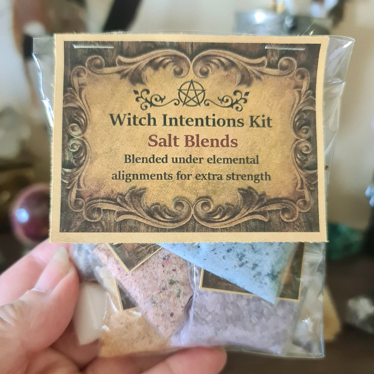 Packaging of Wiccan Intentions Kit containing salt blends in different colors, labeled for various magickal uses such as protection and luck.