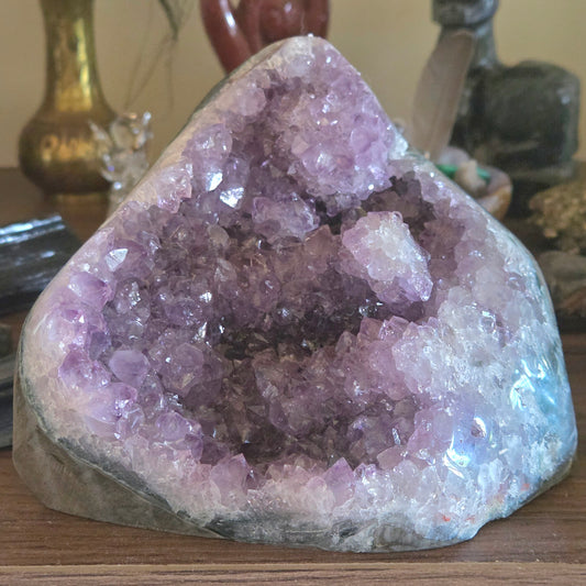 Amethyst crystal geode on a wooden surface with blurred background