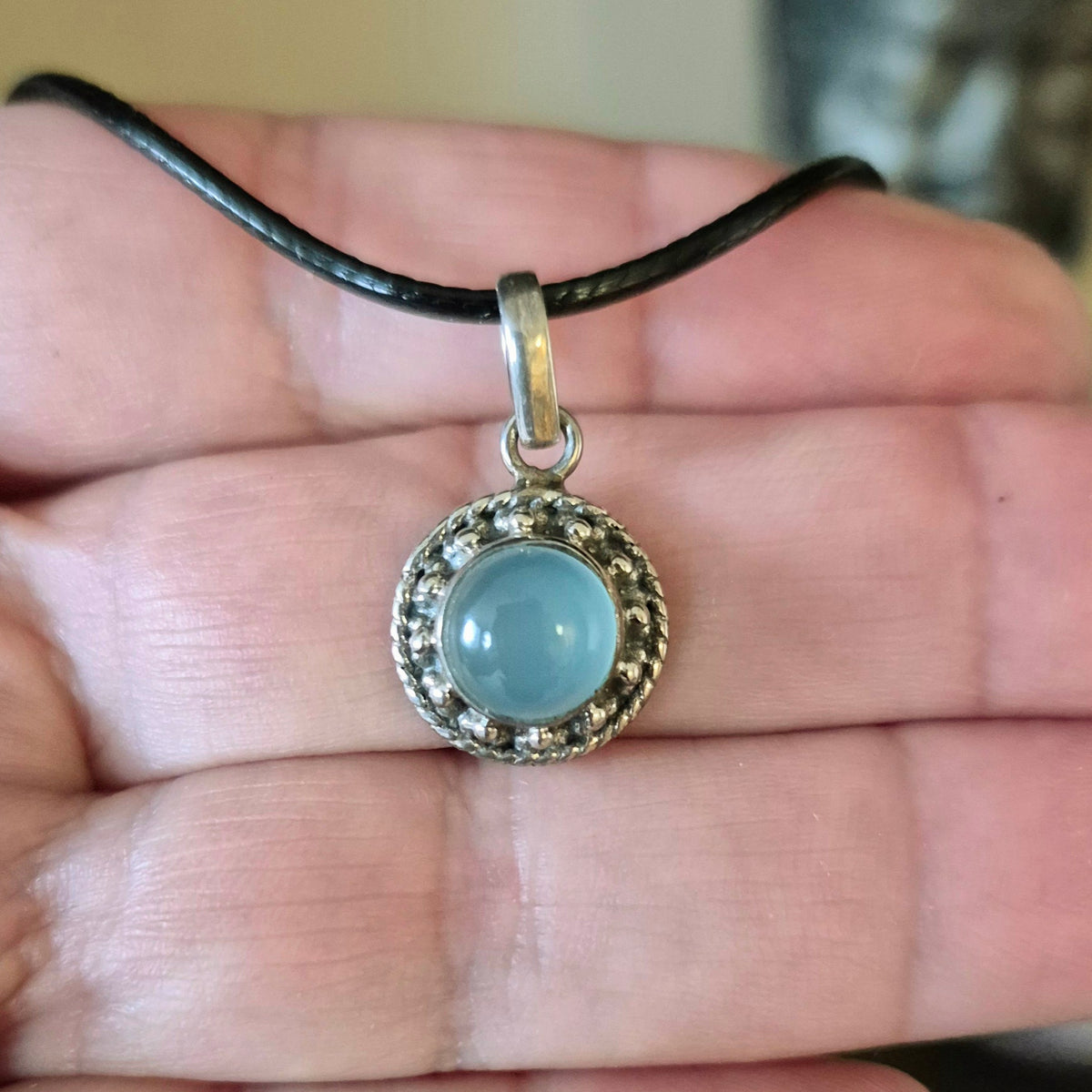 light blue crystal in silver surround
