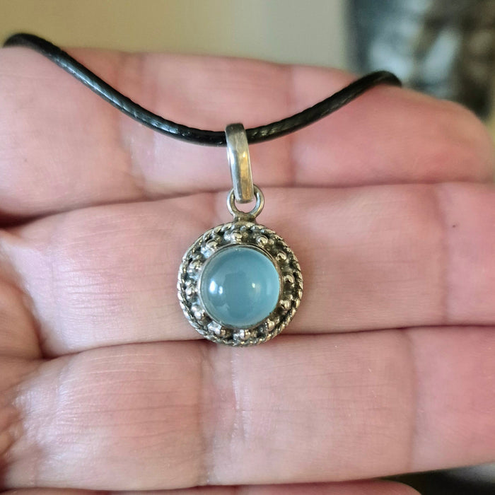 light blue crystal in silver surround