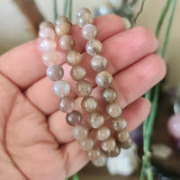 brown and cream crystal bracelet held in hand