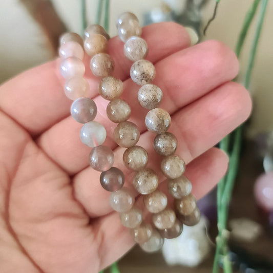 brown and cream crystal bracelet held in hand