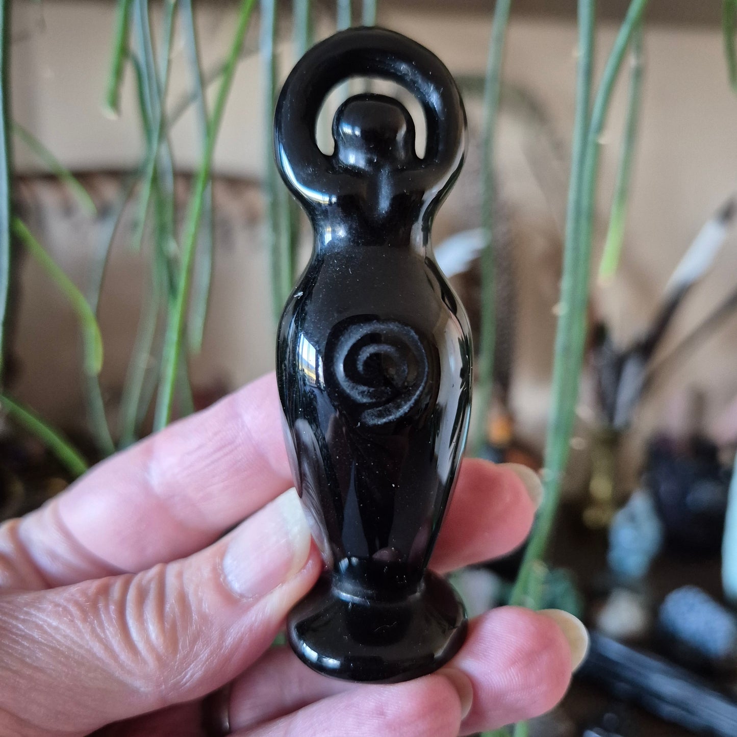 black figure representing a woman made from crystal