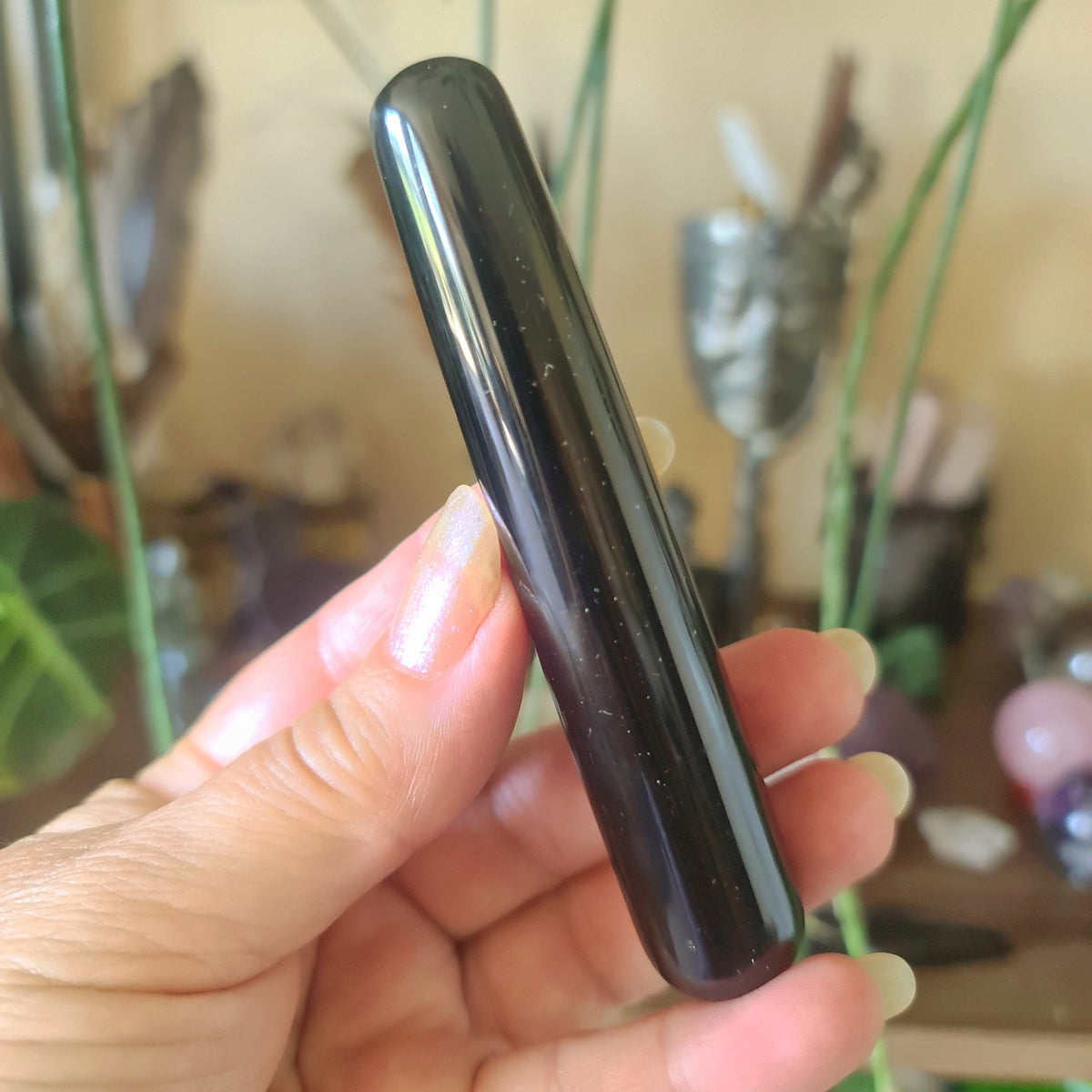 black crystal wand held in a hand