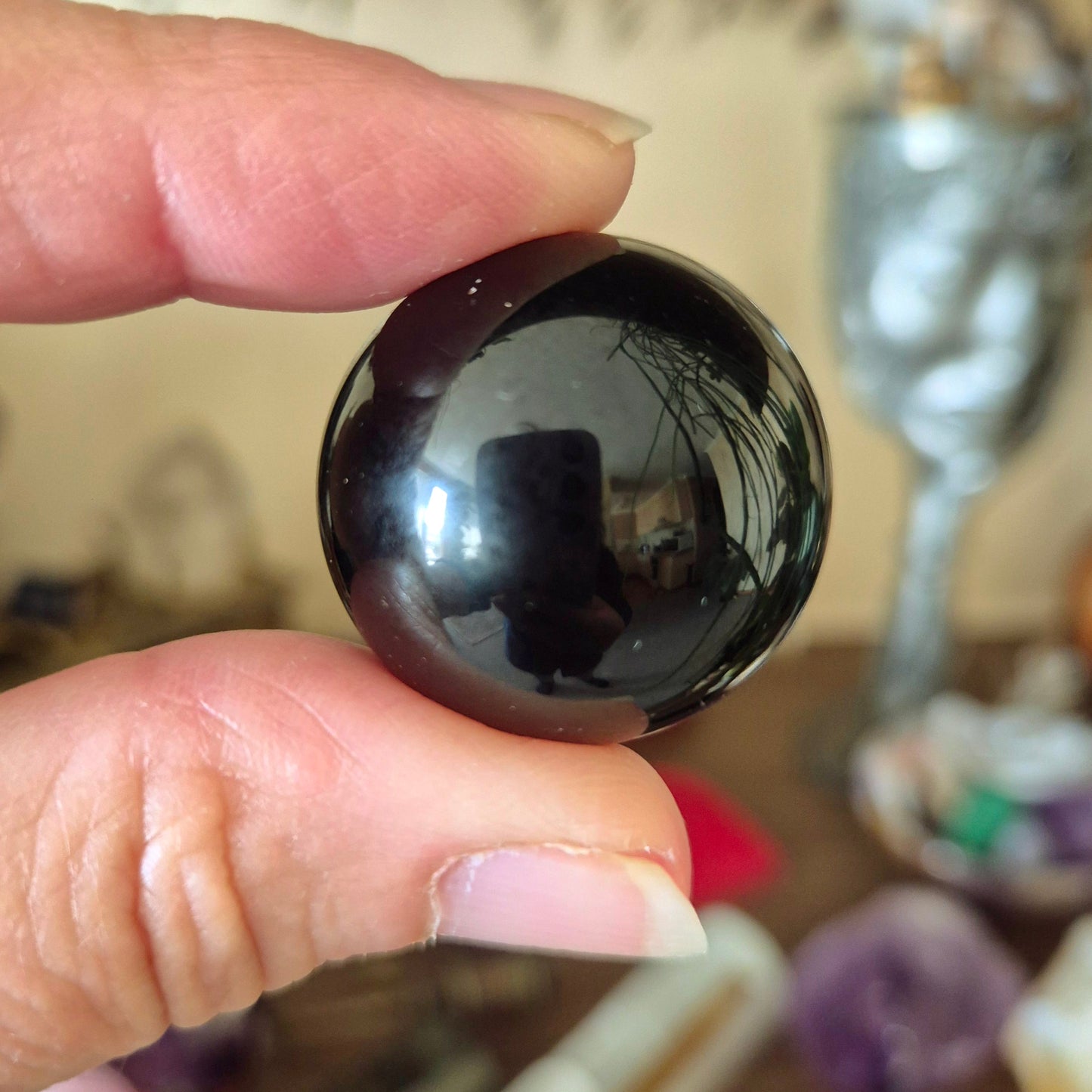 small black crystal sphere held in a hand