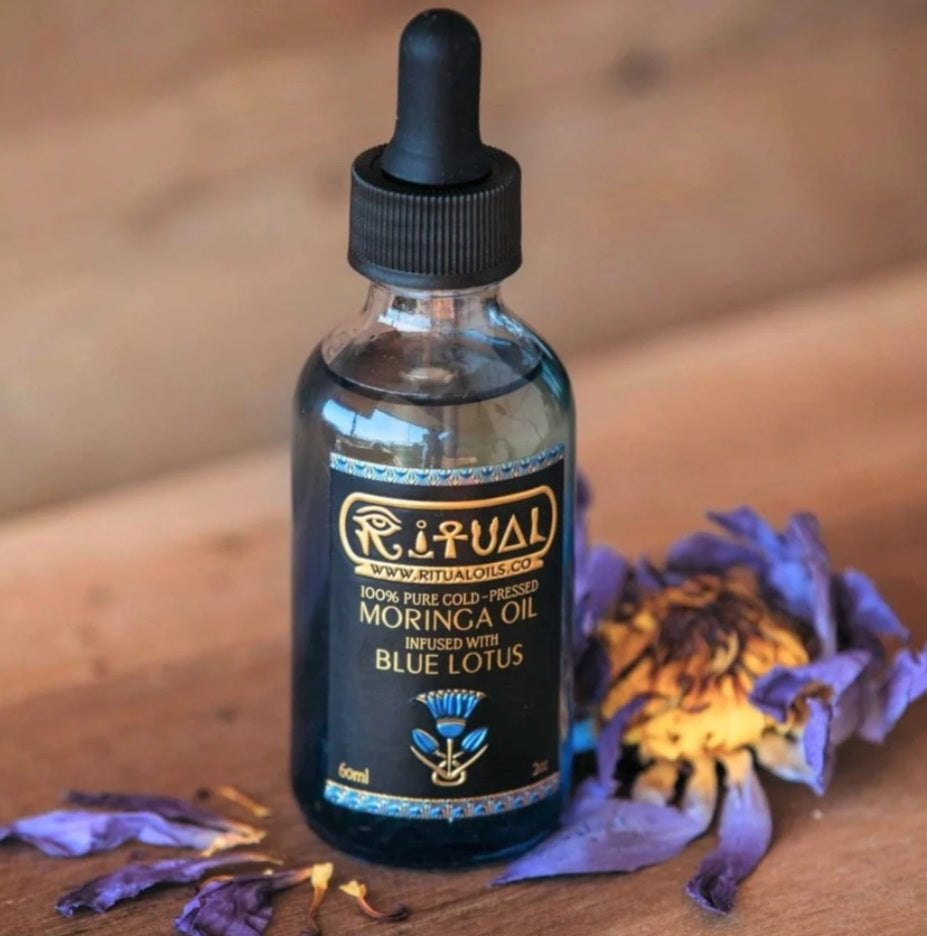 blue lotus oil in a drop bottle on wooden table