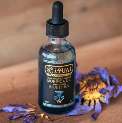 blue lotus oil in a drop bottle on wooden table