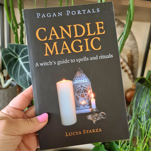 black soft cover book held in a hand