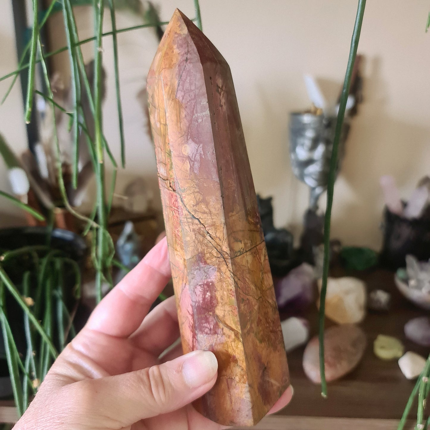 cherry and brown coloured crystal tower in a ahnd