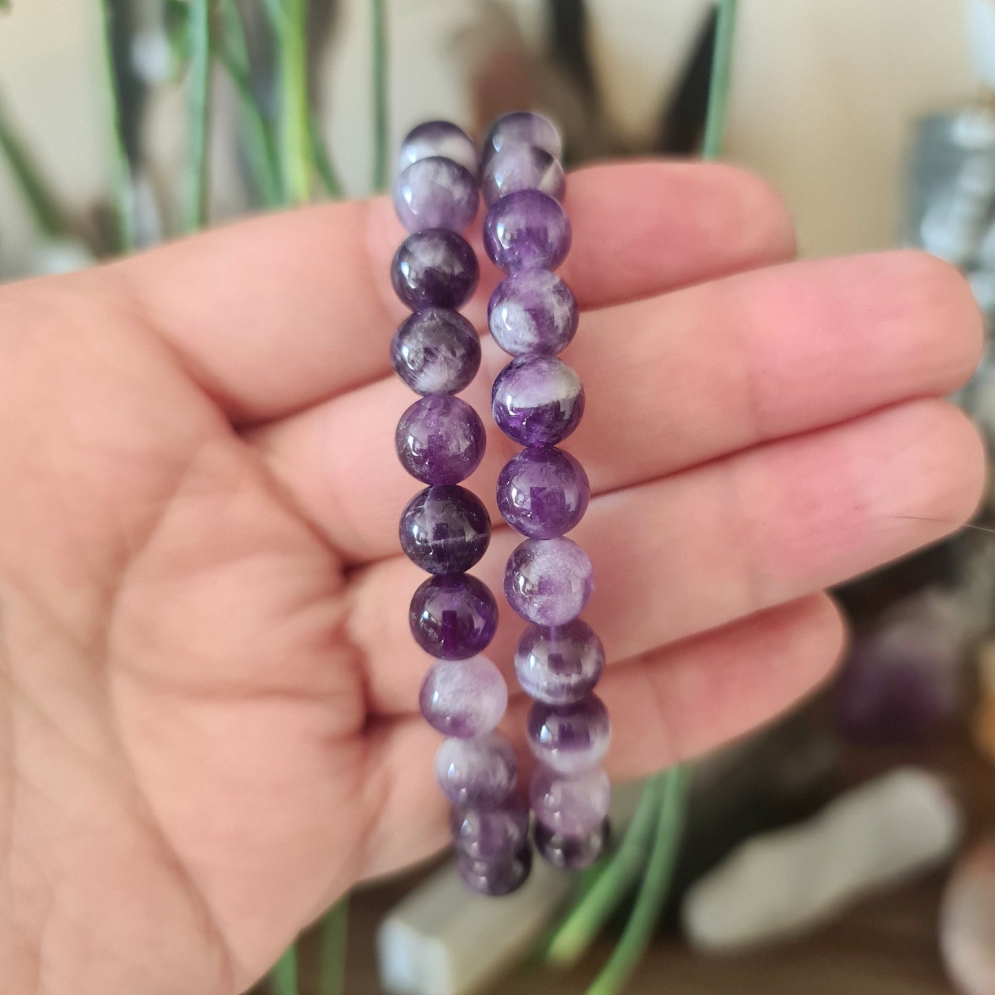 purple and white crystal bracelets on a ahand