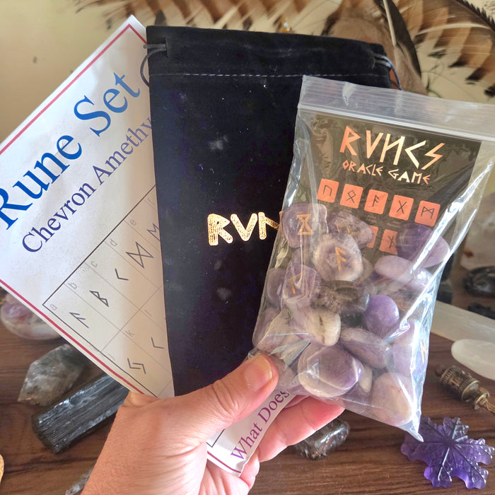 Rune set packaging with stones and instructions on a wooden surface