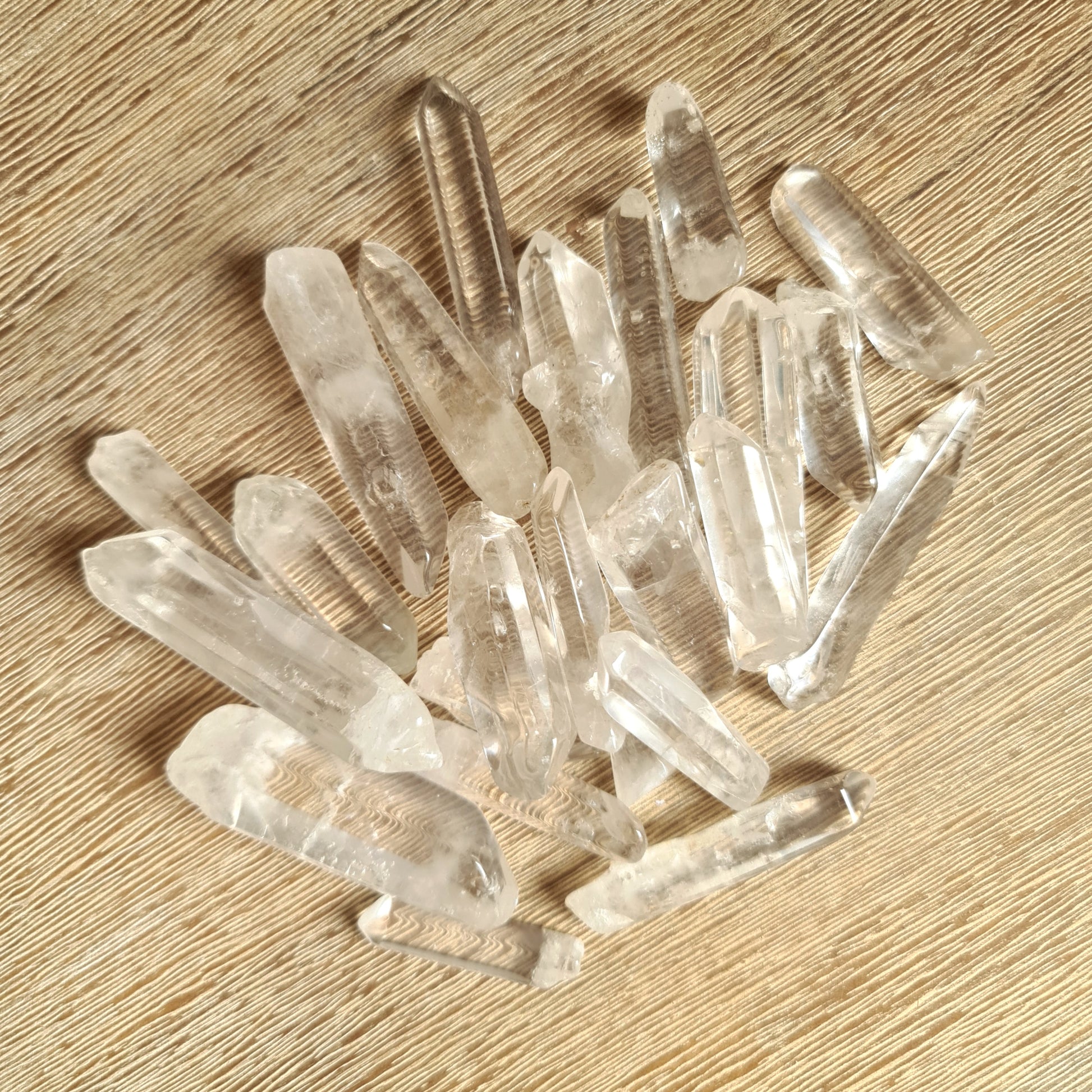 clear quartz crystal points on wooden background