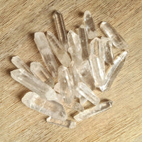 clear quartz crystal points on wooden background