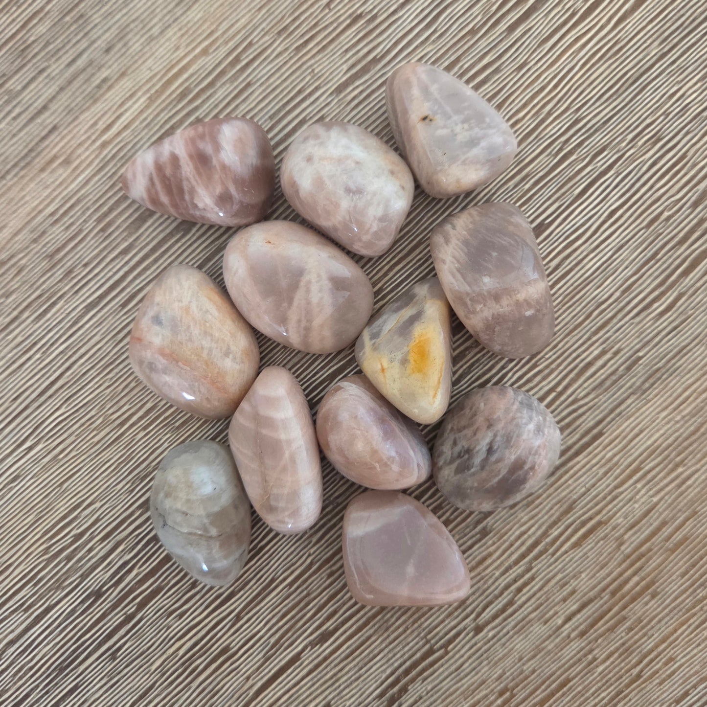 Collection of polished stones on a wooden surface
