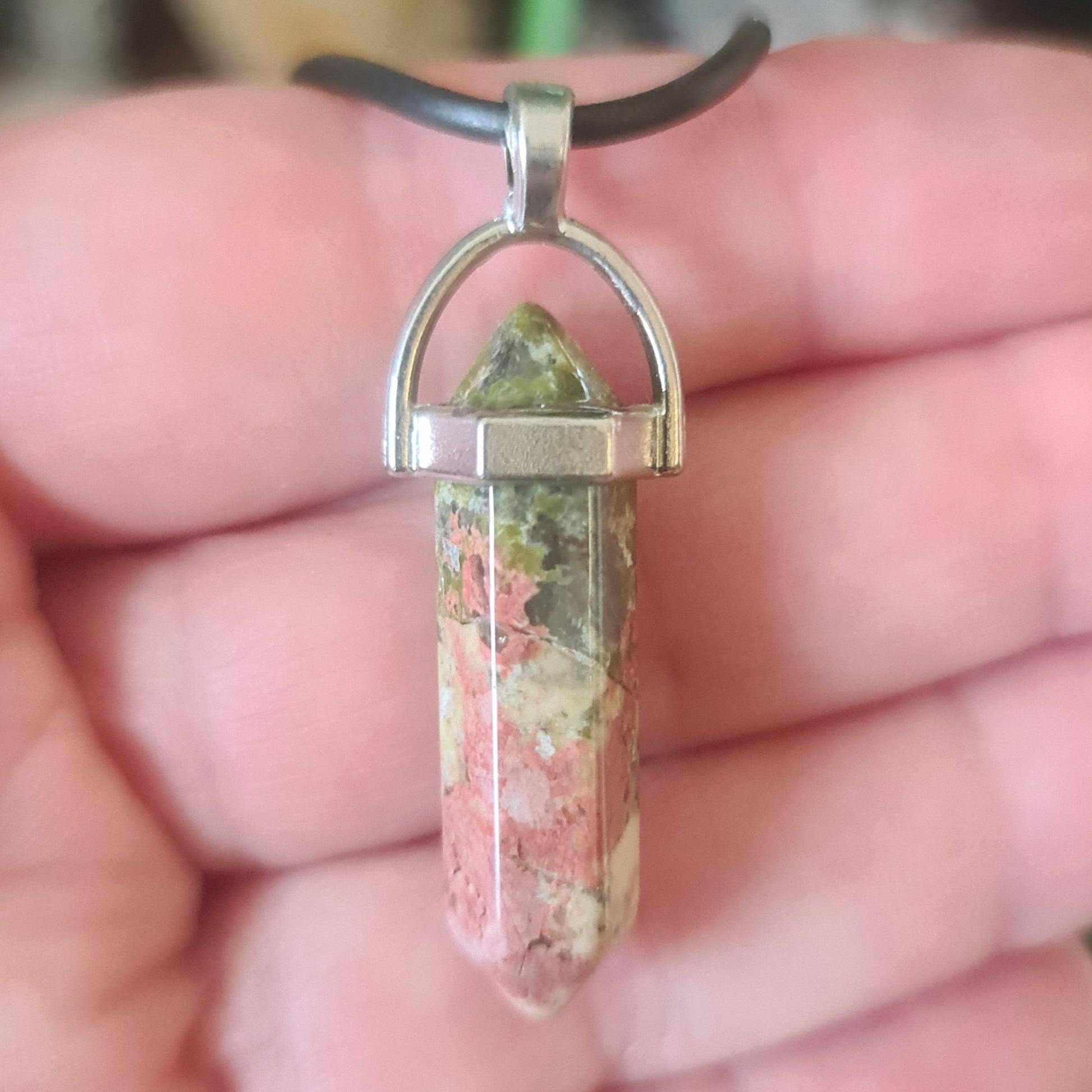 A sterling silver necklace with a teardrop-shaped crystal point pendant.