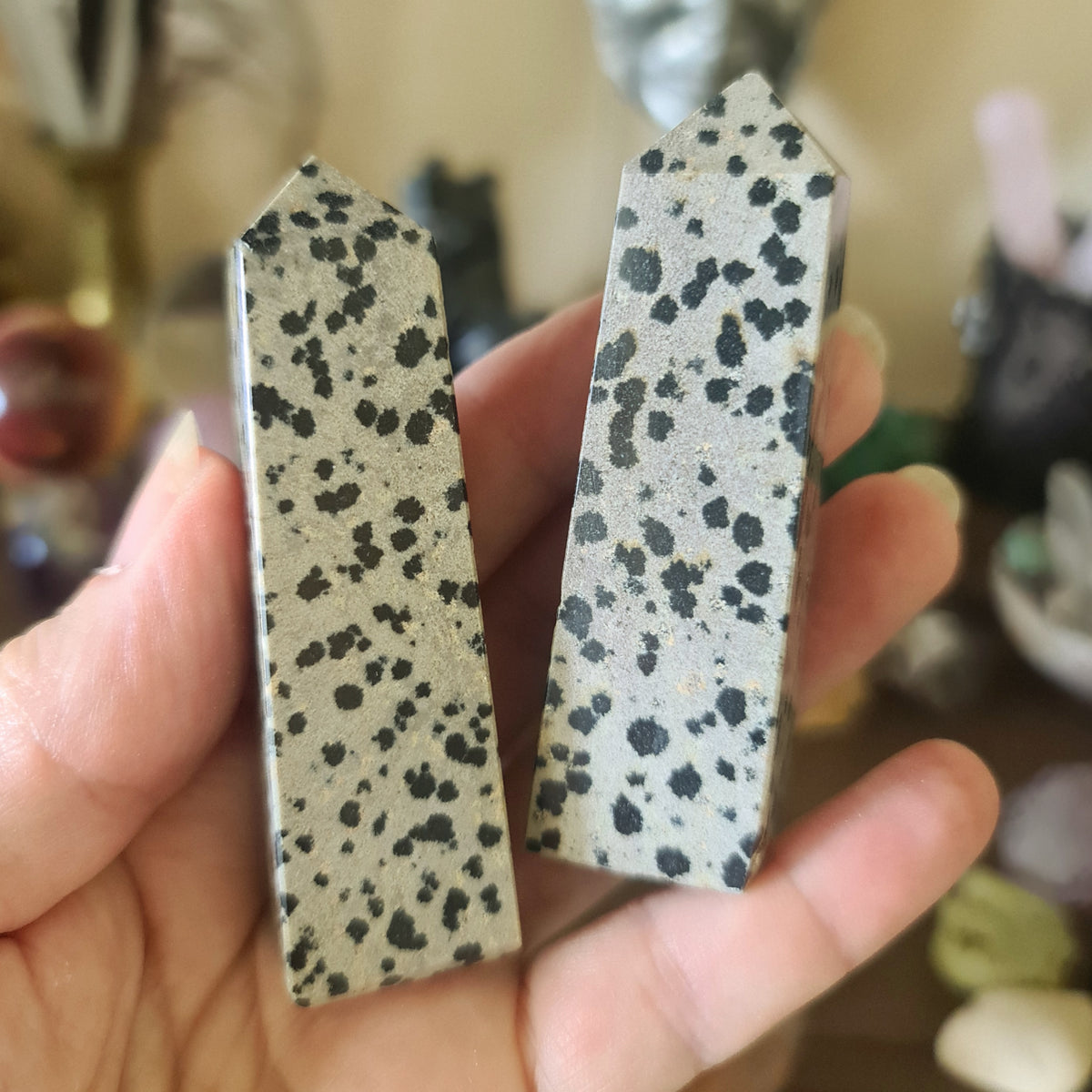 beige spotted crystal towers on a hand