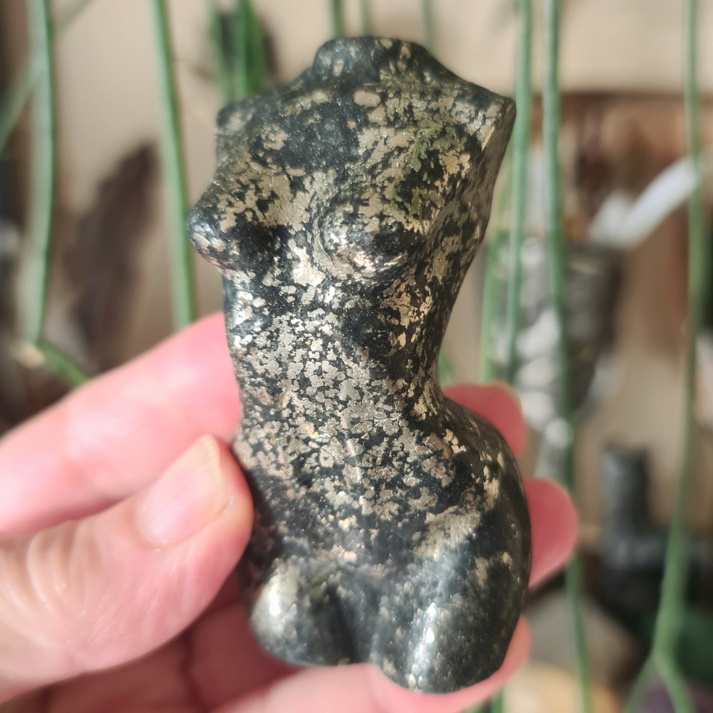 crystal torso held in a hand