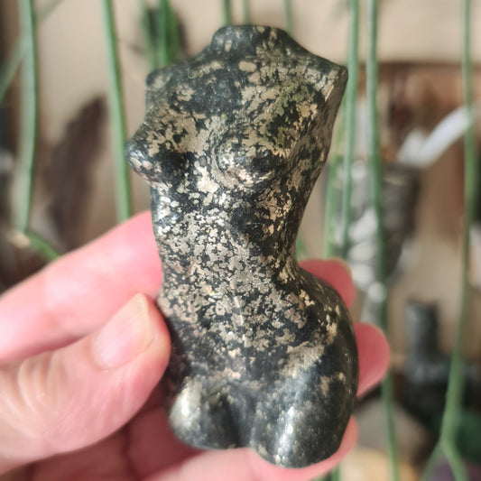 crystal torso held in a hand