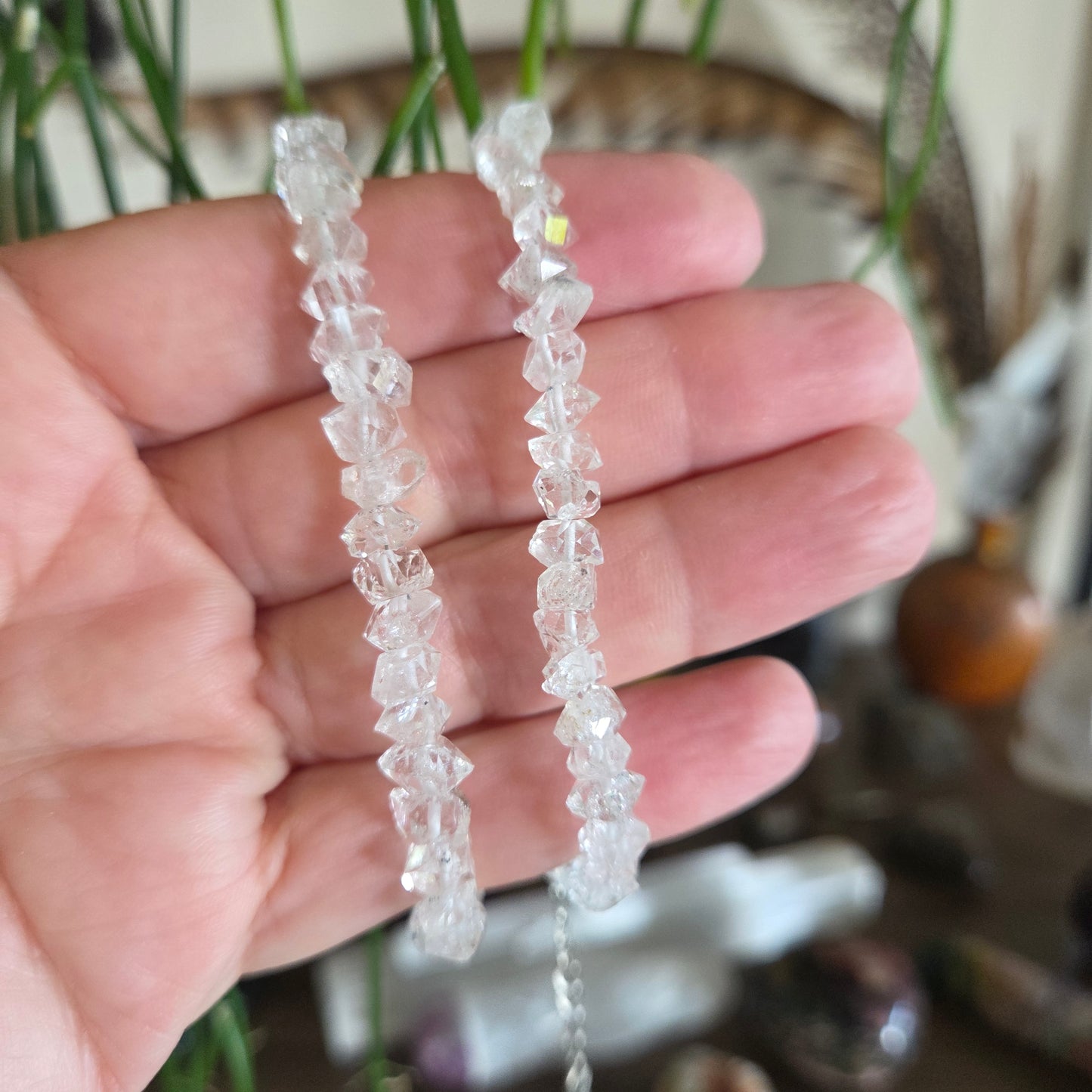 Two crystal bracelets on a hand with a blurred natural background