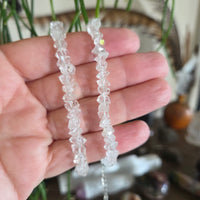 Two crystal bracelets on a hand with a blurred natural background