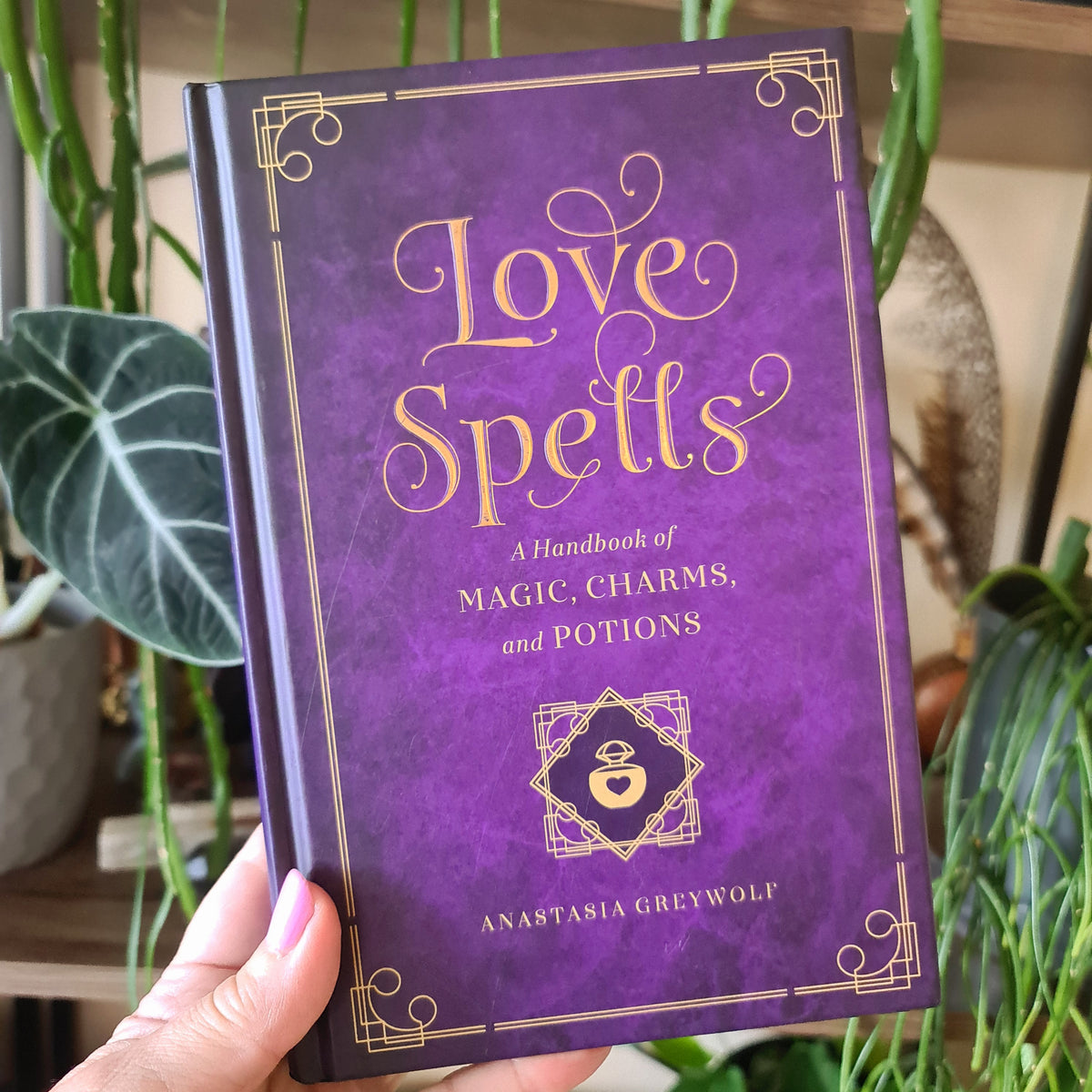 purple hardcover book held in a hand