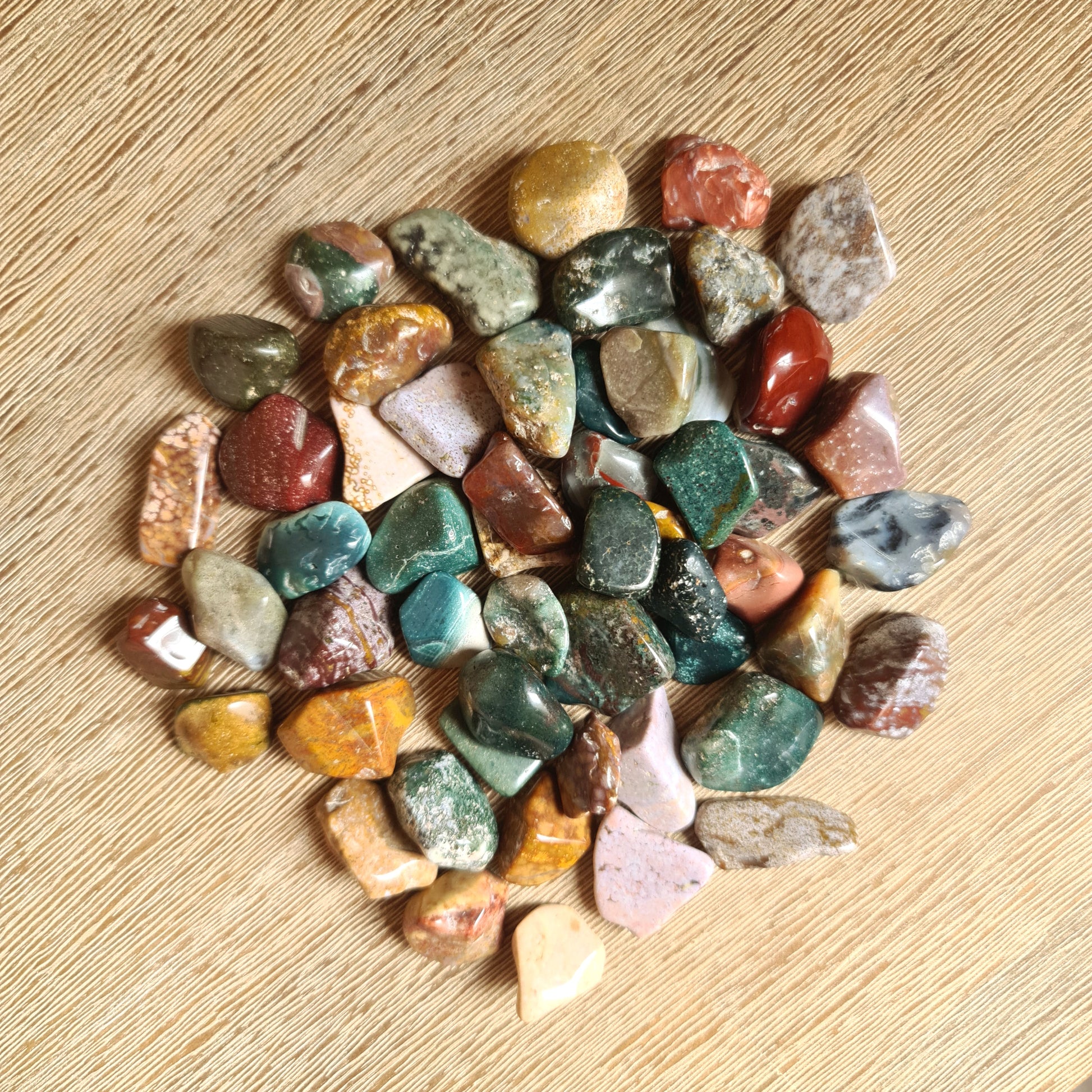 range of coloured crystal pieces on a wooden table