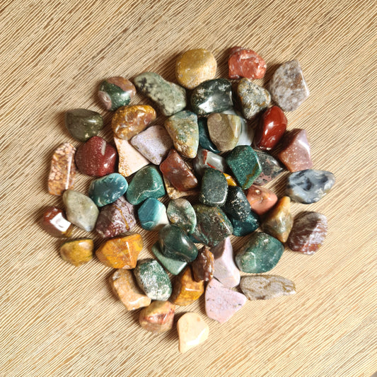range of coloured crystal pieces on a wooden table