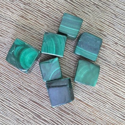 Green marbled cubes on a wooden surface