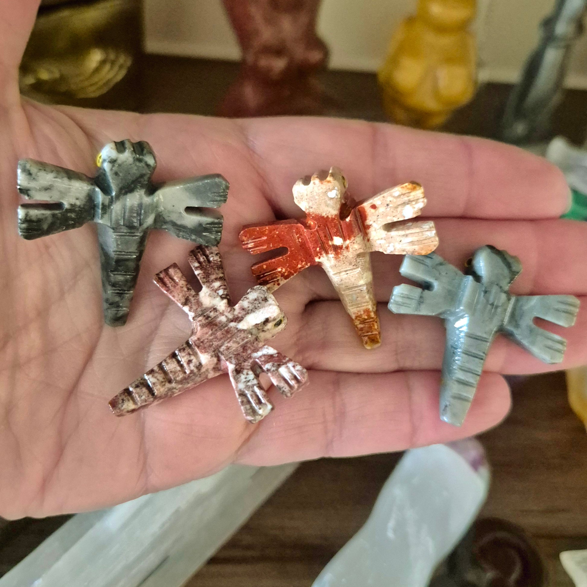 A collection of Marmoline stone dragonflies in various colors held in a person's hand.