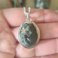large raw moldavite pendant set in sterling silver