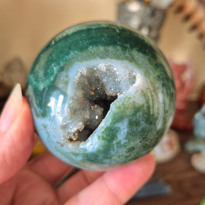 green crystal ball with druzy cave