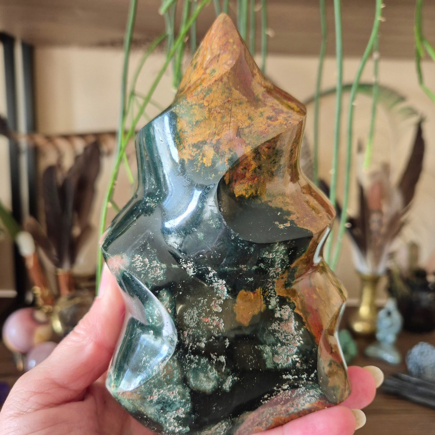 green and brown crystal in a flame design