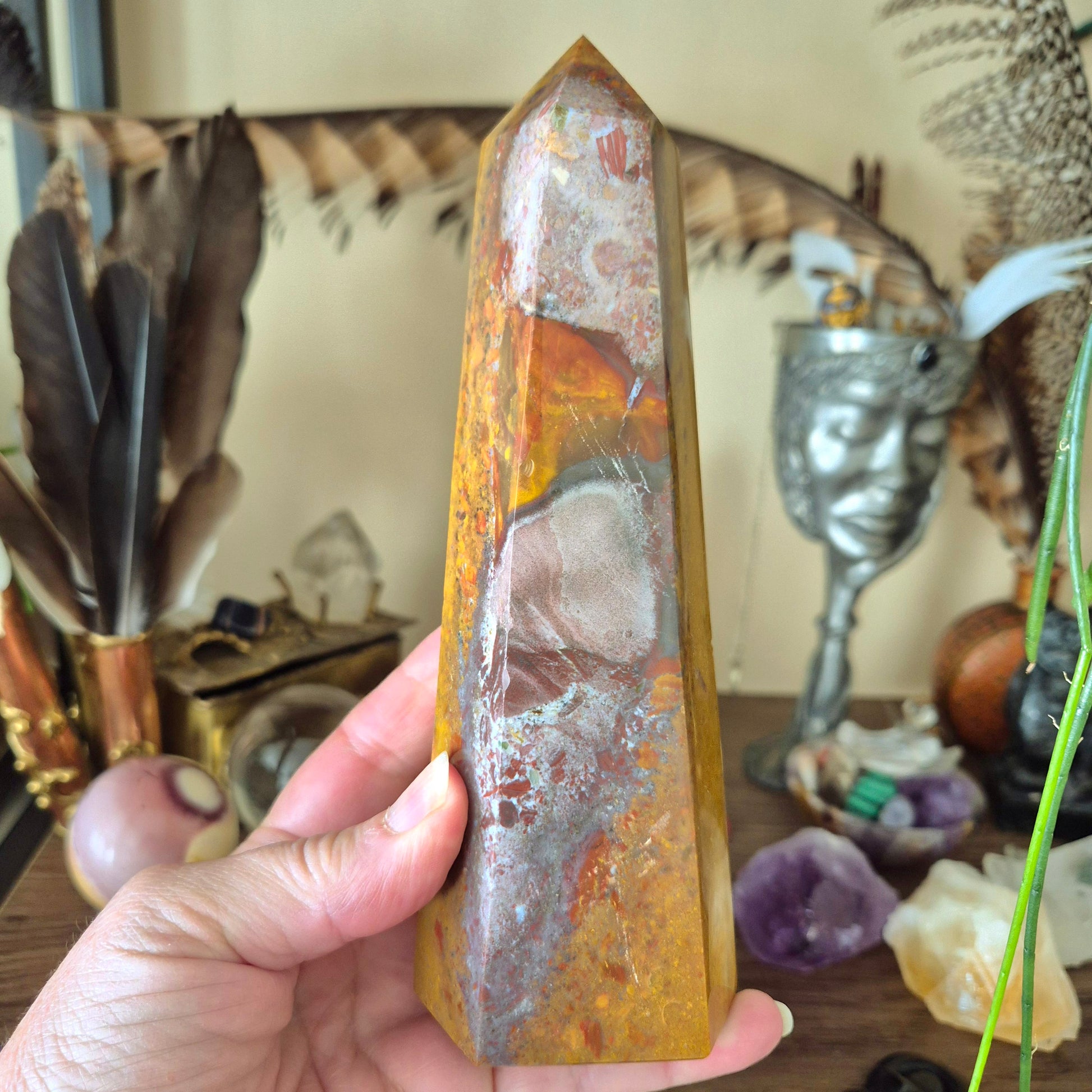 large ocean jasper tower held in a hand