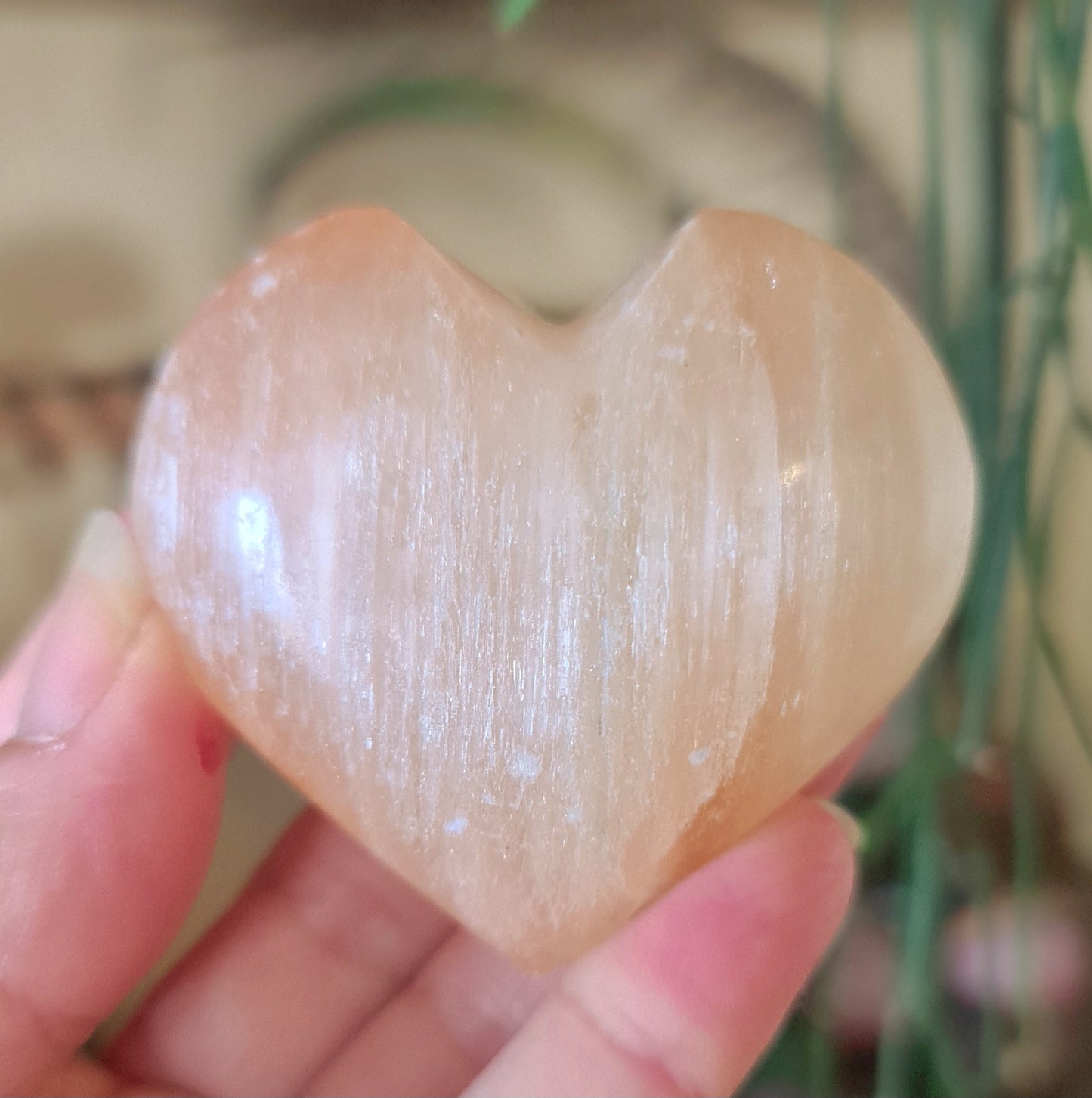 pale peach crystal heart in a hand
