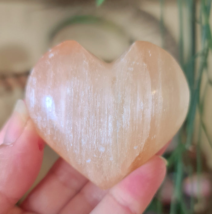 pale peach crystal heart in a hand