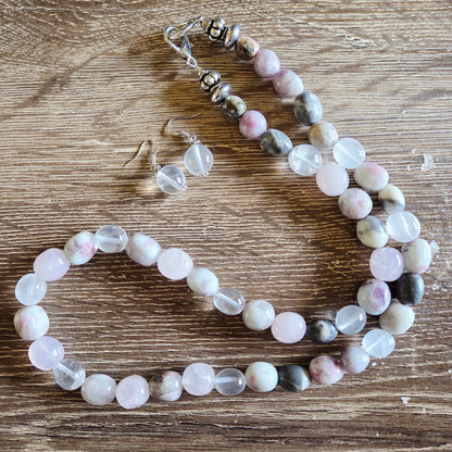 Beaded necklace and earrings on a wooden surface
