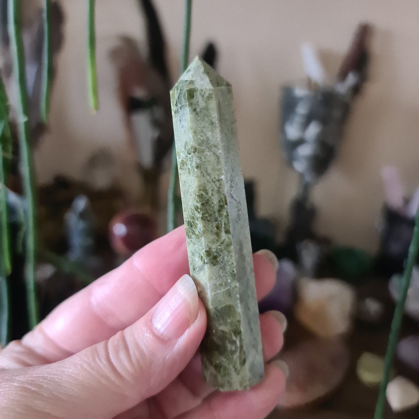 green crystal points in a hand