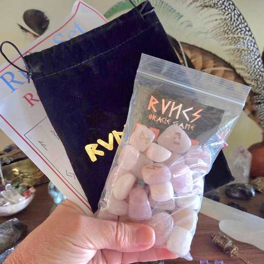 Bag of crystals with 'rune' branding held by a hand, on a table with various items.