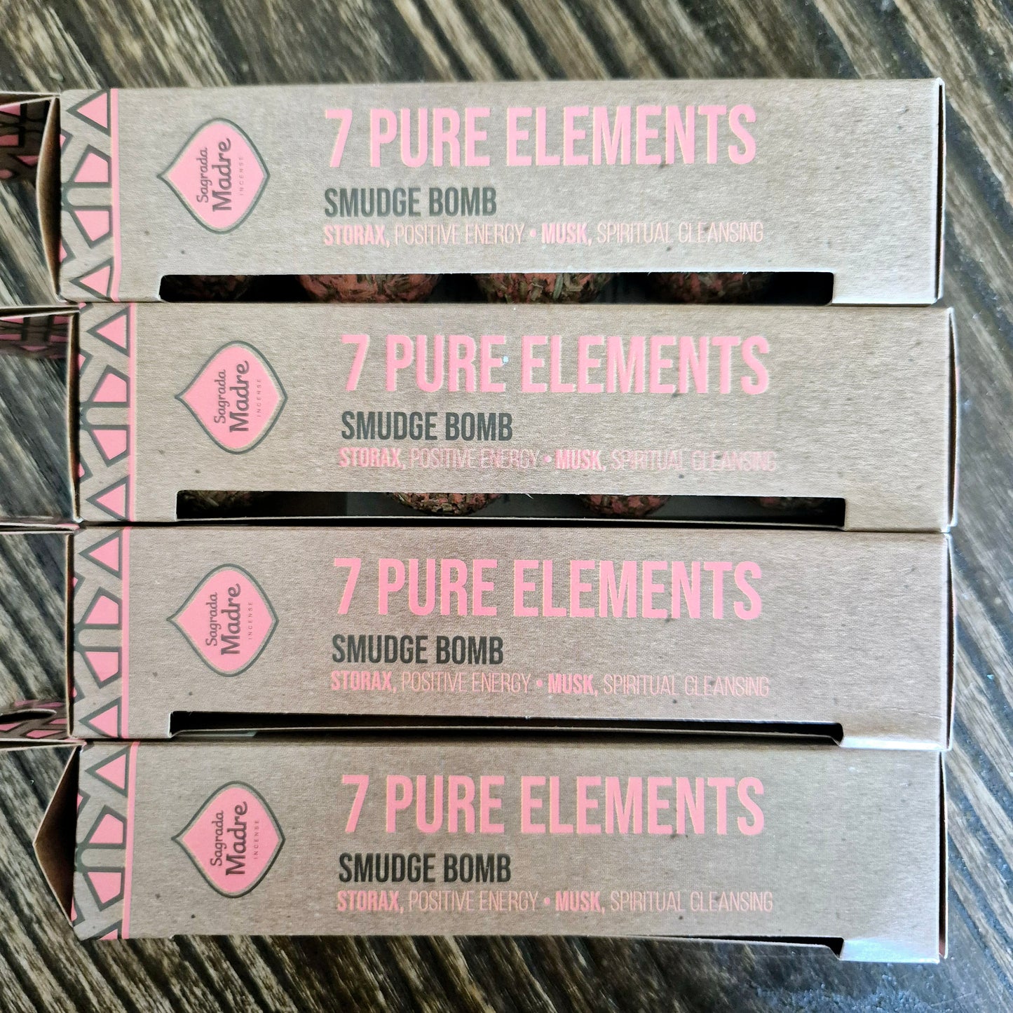 A box labeled '7 Pure Elements Smudge Bomb' with text indicating the product is a sage smudge bomb, meant for spiritual cleansing and clearing, with properties of calm, positivity, and spiritual clarity.