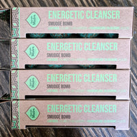 Packaging for 'Energetic Cleanser Sage Smudge Bomb', featuring green text and design elements on a cardboard box with a visible green and white design on the box lid.