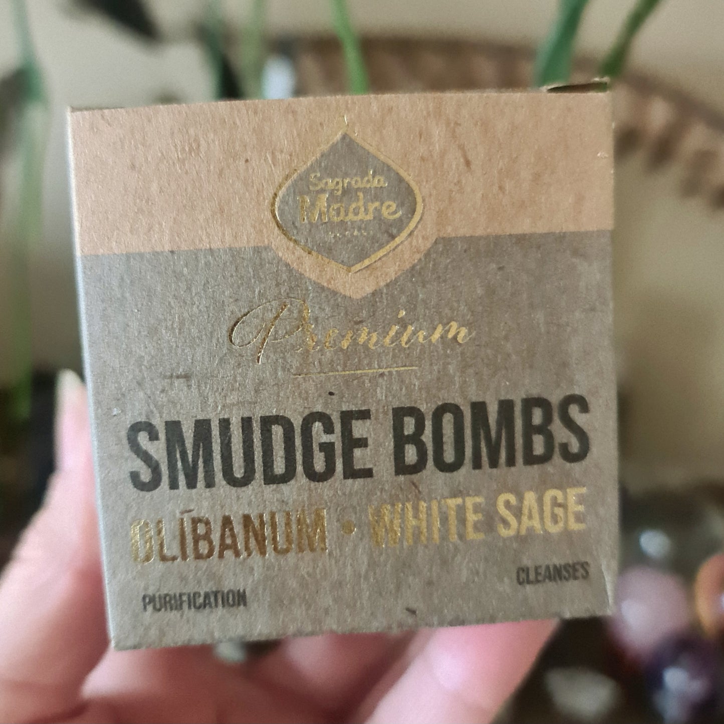 A package of Sage Smudge Bombs labeled 'Premium' with the ingredients listed as Olibanum and White Sage, indicating the smudge bombs are used for cleansing and purification.