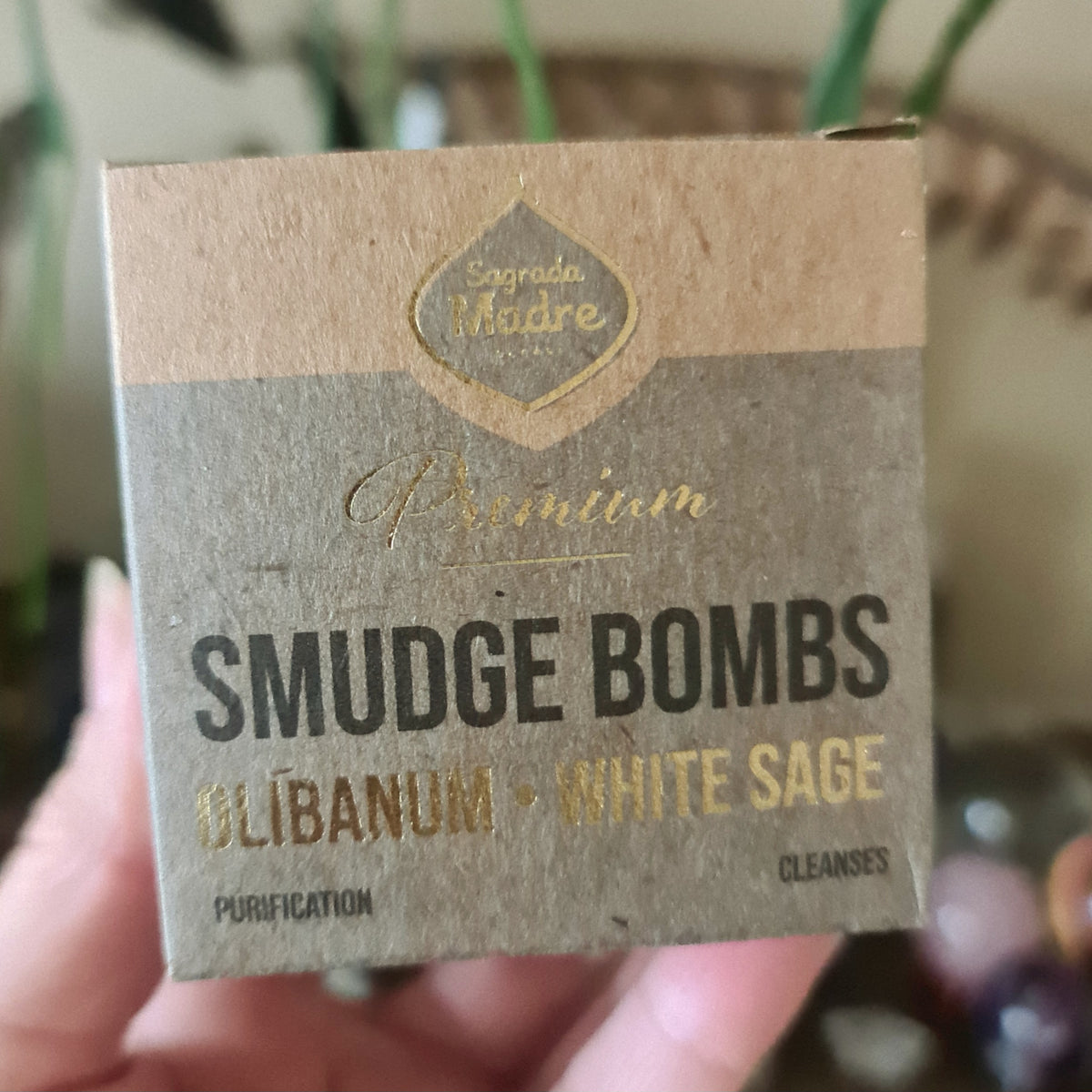 A package of Sage Smudge Bombs labeled 'Premium' with the ingredients listed as Olibanum and White Sage, indicating the smudge bombs are used for cleansing and purification.