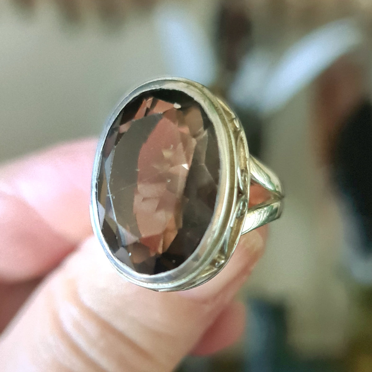 A smoky quartz crystal ring, size 8, set in a sterling silver band.