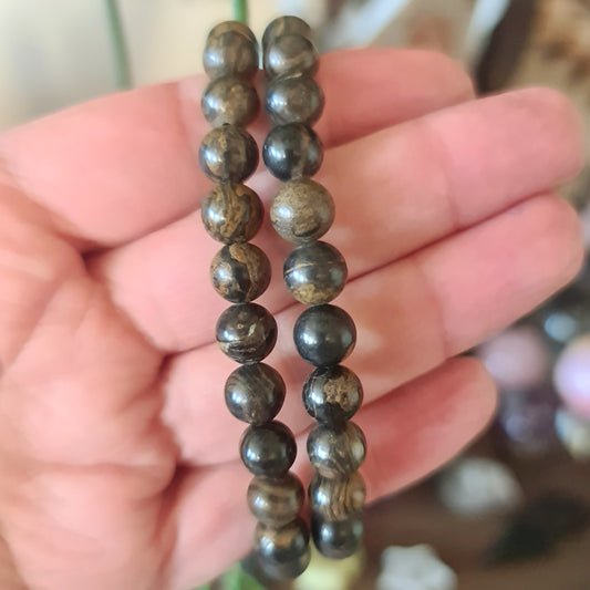 brown crystal bracelet held in a hand