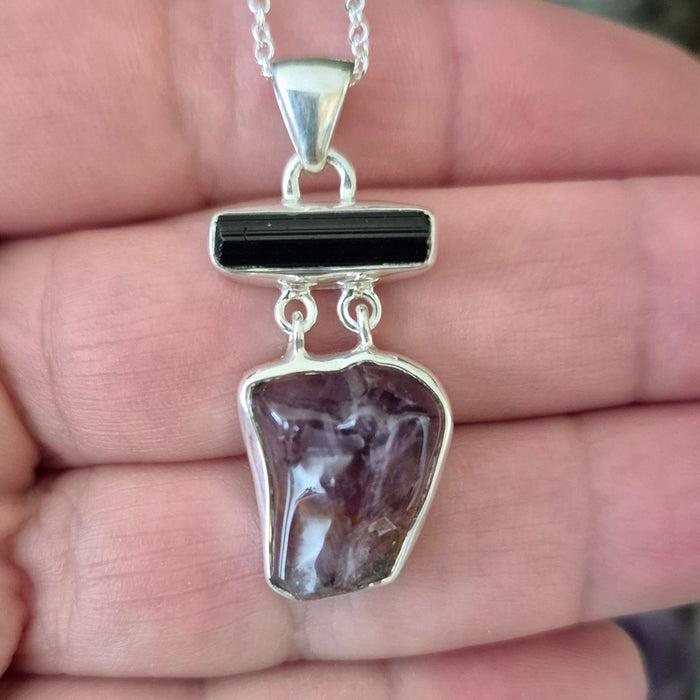 purple crystal and black crystal in a sterling silver pendant